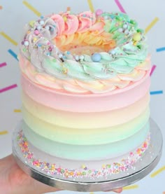 there is a rainbow cake with sprinkles on it