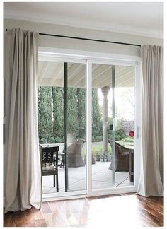 a living room filled with furniture and sliding glass doors