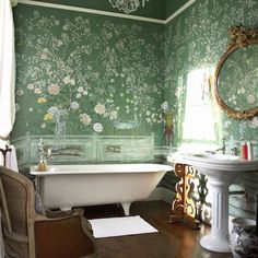 an old fashioned bathroom with green wallpaper