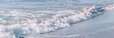 there is a message written on the sand at the beach with waves coming in to shore