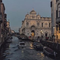 boats are parked on the water in front of buildings