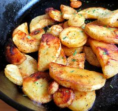 cooked potatoes in a skillet with seasoning on the side, ready to be eaten