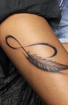 a woman's thigh with a tattoo on it and an arrow in the middle