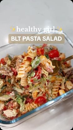 a glass dish filled with pasta salad on top of a table