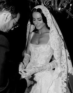 the bride is getting ready to walk down the aisle in her wedding dress and veil