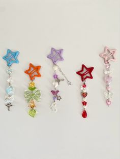 six different colored stars and beads on a white surface