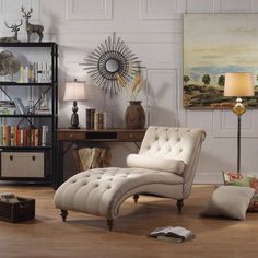 a living room with a chaise lounge chair and bookshelf