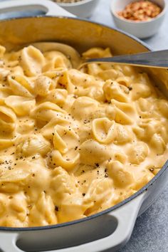 a pot filled with macaroni and cheese on top of a table