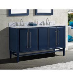 a bathroom vanity with marble counter top and blue cabinet doors, gold faucets