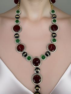 Sabyasachi inspired designer necklace set, made in copper and blakish polish, studded with Ruby and Emerald stones and white CZ stones. Very smooth finishing, looks stylish upon wearing. Perfect for party wear. Dimension: 9.5" long w/ 3" long pendant  Earrings: 2.5" long Weight: 5.4 oz and w/ packaging 7 oz Luxury Necklace With Stones For Celebration, Festive Black Round Necklace, Festive Black Necklace, Luxury Necklaces With Jewels For Festive Occasions, Luxury Jeweled Necklaces For Festive Occasions, Luxury Festive Necklaces With Jewels, Elegant Black Temple Necklace As Gift, Elegant Black Temple Necklace Gift, Elegant Black Kundan Necklace For Celebrations