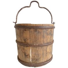 an old wooden bucket with metal handles