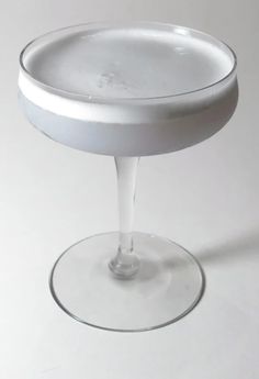 an empty wine glass sitting on top of a table