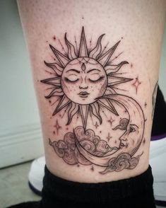 a sun and moon tattoo on the leg