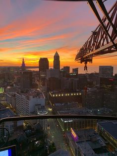 the city skyline is lit up at sunset from an observation point on top of a skyscraper