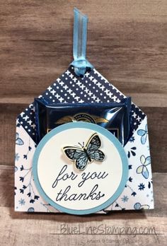 a blue and white box with a butterfly on it that says for you thanks to all of us