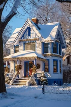 a blue and white house covered in snow