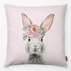 a pillow with an image of a rabbit wearing a flower crown on it's head