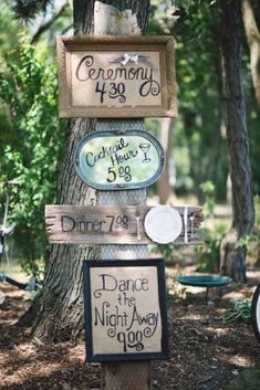 several signs are posted in the woods for wedding guests to take pictures and put on them