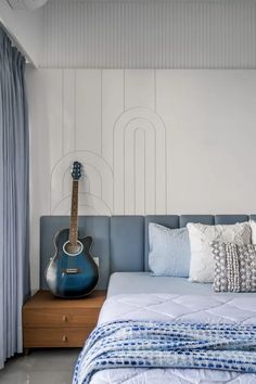 a bed with a guitar on top of it