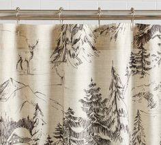 a shower curtain with trees and mountains drawn on it