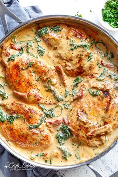 chicken with gravy in a skillet next to some parsley on the side