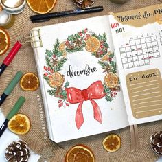 an open planner with oranges around it