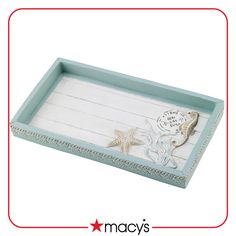 a wooden tray with starfish and shells on it