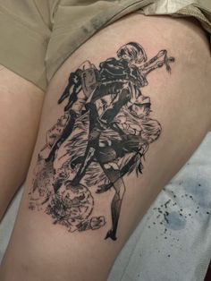 a woman's thigh with an anime tattoo on her left leg and the image of two people