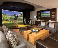 a living room filled with furniture and a large screen tv mounted to the side of a wall