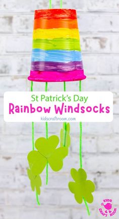 st patrick's day rainbow windocks with shamrocks hanging from the strings and text overlay that says, st patrick's day rainbow windsocks