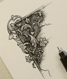 a pen and ink drawing of an ornate design on white paper with a black marker