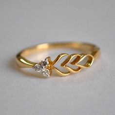 "A unique take on the classic 3 diamond ring, An asymmetric ring with mini cluster of 3 round diamonds on one side and a leaf filigree design on the other. A delight for everyday use * Diamond Wt. : 0.09 cts * Color-Clarity Grade : H-I, Vs-Si * Gold - 14k, yellow gold If you like this ring, please press \"Pin it\" button on the right of your screen. Find us on Instagram for exquisite designs: @abhikajewels Like us on Facebook: www.facebook.com/Abhikajewels Thank you for visiting our shop.. :)" Simple Finger Ring Design, Finger Rings Designs Gold, Gold Fancy Rings, 3 Diamond Ring Design, Minimal Gold Jewelry Aesthetic, Unique Right Hand Rings, Diamond Ring For Engagement, Light Weight Rings Gold, Womens Gold Rings