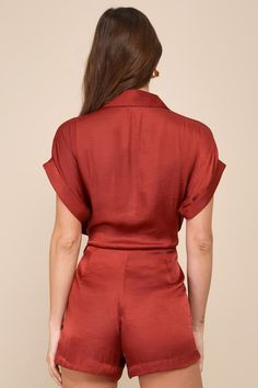 From everyday events to dressy occasions, the Steve Madden Tori Rust Red Satin Collared Dolman Sleeve Button-Up Romper is always the right choice! Sleek woven satin shapes this elevated take on a romper that boasts short cuffed dolman sleeves, a collared neckline, and a gathered bodice with a functional button placket at the front. Buttons continue across the fitted waist, with a tying sash detail. Attached shorts have side seam pockets and a relaxed fit to complete the look. Fit: This garment f Red Button-up Blouse For Party, Red Button-up Party Blouse, Red Party Top With Button Closure, Chic Red Satin Blouse, Red Party Blouse With Buttons, Elegant Red Satin Blouse, Red Buttoned Party Tops, Red Collared Party Blouse, Elegant Red Collared Blouse