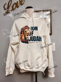 Impactful image of the Lion of Judah sublimated onto hoodie or t-shirt. All material is cotton or poly/cotton. Perfect for a gift for that someone that needs reminding who they belong to. Message us if you would like any customizations Cotton Hoodie Sweatshirt With Sublimation Print, White Cotton Hoodie For Fan Merchandise, White Sweatshirt With Sublimation Print, White Hoodie Sweatshirt With Sublimation Print, White Band Merch Hoodie With Graphic Print, Band Merch White Hoodie With Graphic Print, Lion Of Tribe Of Judah, Lion Of Judah With Crown, White Hooded Sweatshirt With Sublimation Print