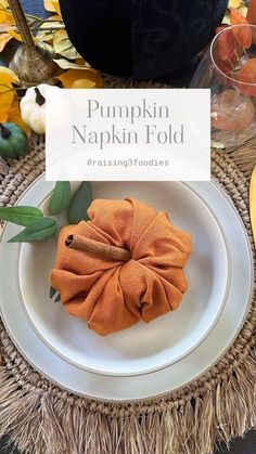 the pumpkin napkin fold is sitting on a plate