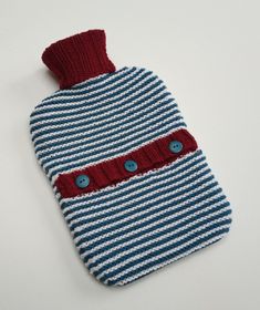 a blue and white striped knitted bag with buttons