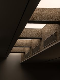 an empty room with several air conditioners on the ceiling