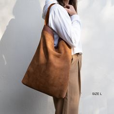 "Suede Leather Bag by ELEVEN600 Shop. Beautiful Suede leather Hobo bag, natural. DETAILS: -This tote bag comes with an internal pocket, leather keychain and magnetic closure. -Simple and stylish. DIMENSIONS SIZE M: Height: 13,8\" inches / 35 cm Width: 15,8\" inches / 40 cm Depth: 3,5\" inches / 8 cm Strap: 20,47\" inches / 52cm 6,3\" /16cm long from top of the bag DIMENSIONS SIZE L: Height: 19,6\" inches / 50 cm Width: 15,54\" inches / 42 cm Depth: 2,76\" inches / 7 cm Strap: 20,47\" inches / 52 Simple Leather Bag, Full Grain Leather Bag, Shopping Tote Bags, Suede Tote Bag, Real Leather Handbags, Linen Bag, Leather Bags Handmade, Leather Hobo Bag, Leather Keychain