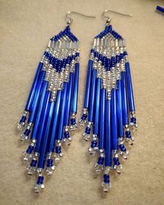 two pairs of blue and silver beaded earrings on top of a white countertop