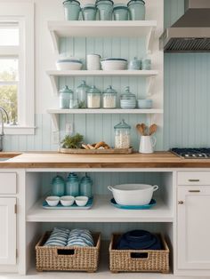 a kitchen with blue and white dishes on shelves