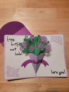 an origami flower bouquet on top of a card with the words happy birthday