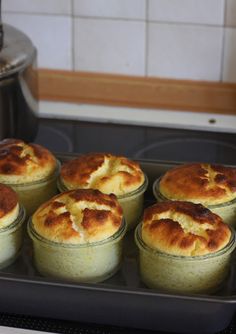 several mini pies are in a pan on the stove