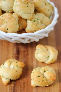 small rolls in a white bowl on a wooden table