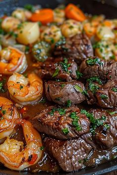 steak, shrimp and carrots are being cooked in a skillet