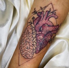 a person with a tattoo on their arm that has a heart and brain in it