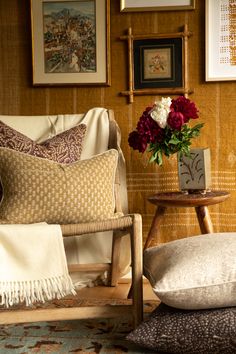 a living room filled with lots of furniture and flowers on top of a wooden table