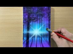 a person is painting an image on a piece of paper with a paintbrushes