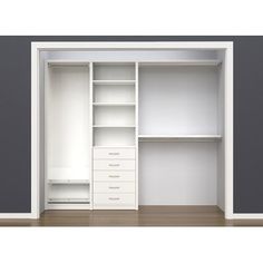 an empty white closet with drawers and shelves