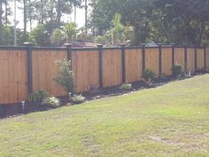 a wooden fence in the middle of a yard