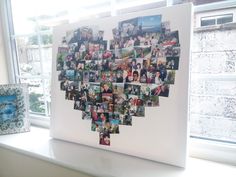 a heart shaped photo hanging on a window sill